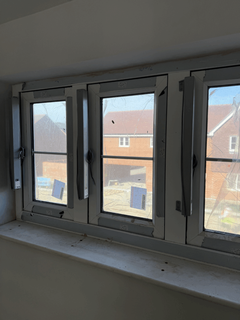 Side-mounted electric window Controls and actuators installed on multiple casement windows for automated natural ventilation in a UK residential development