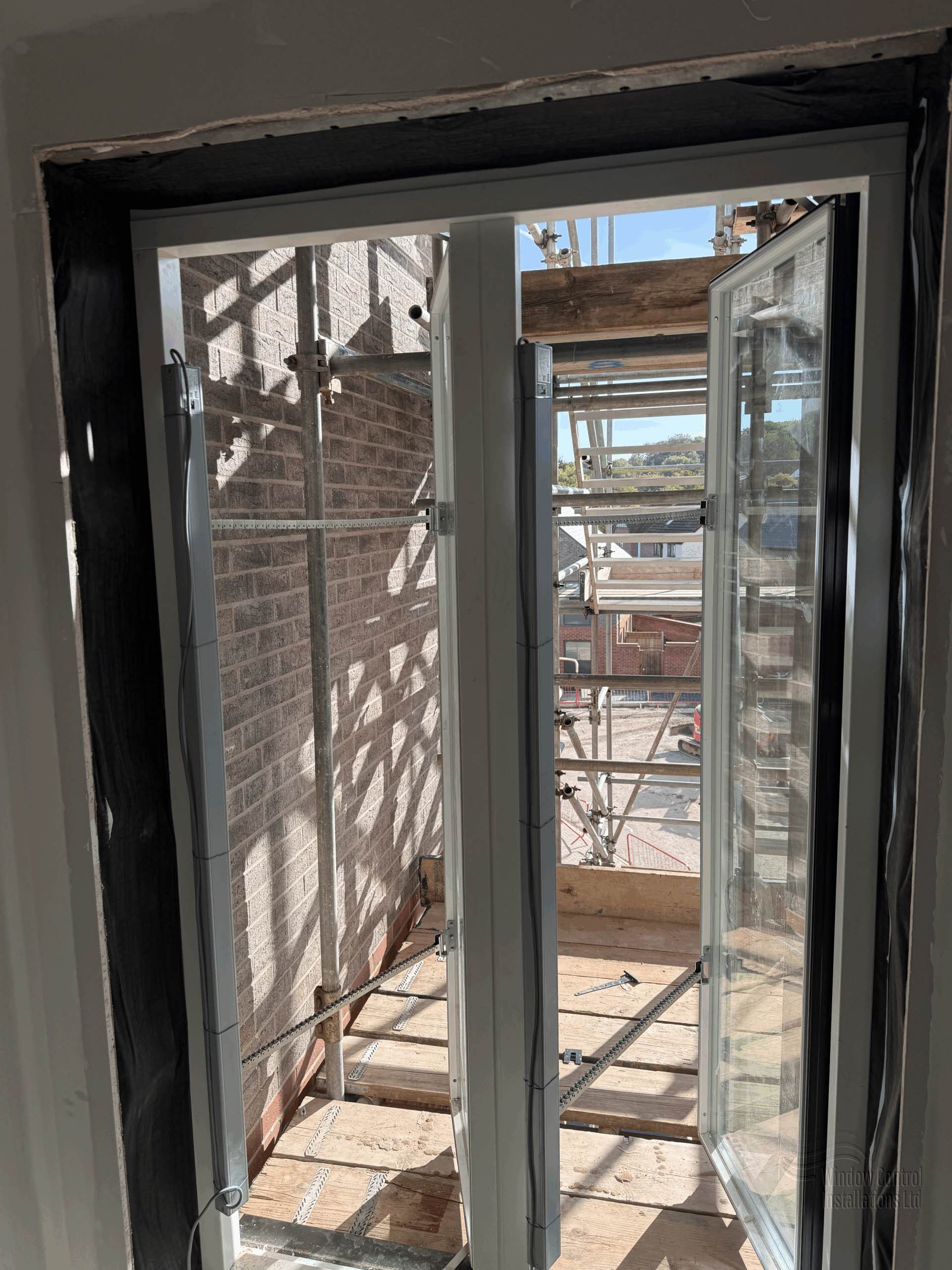 SE Controls electric chain actuator system fitted to vertical windows for Automatic Opening Vent (AOV) smoke control.