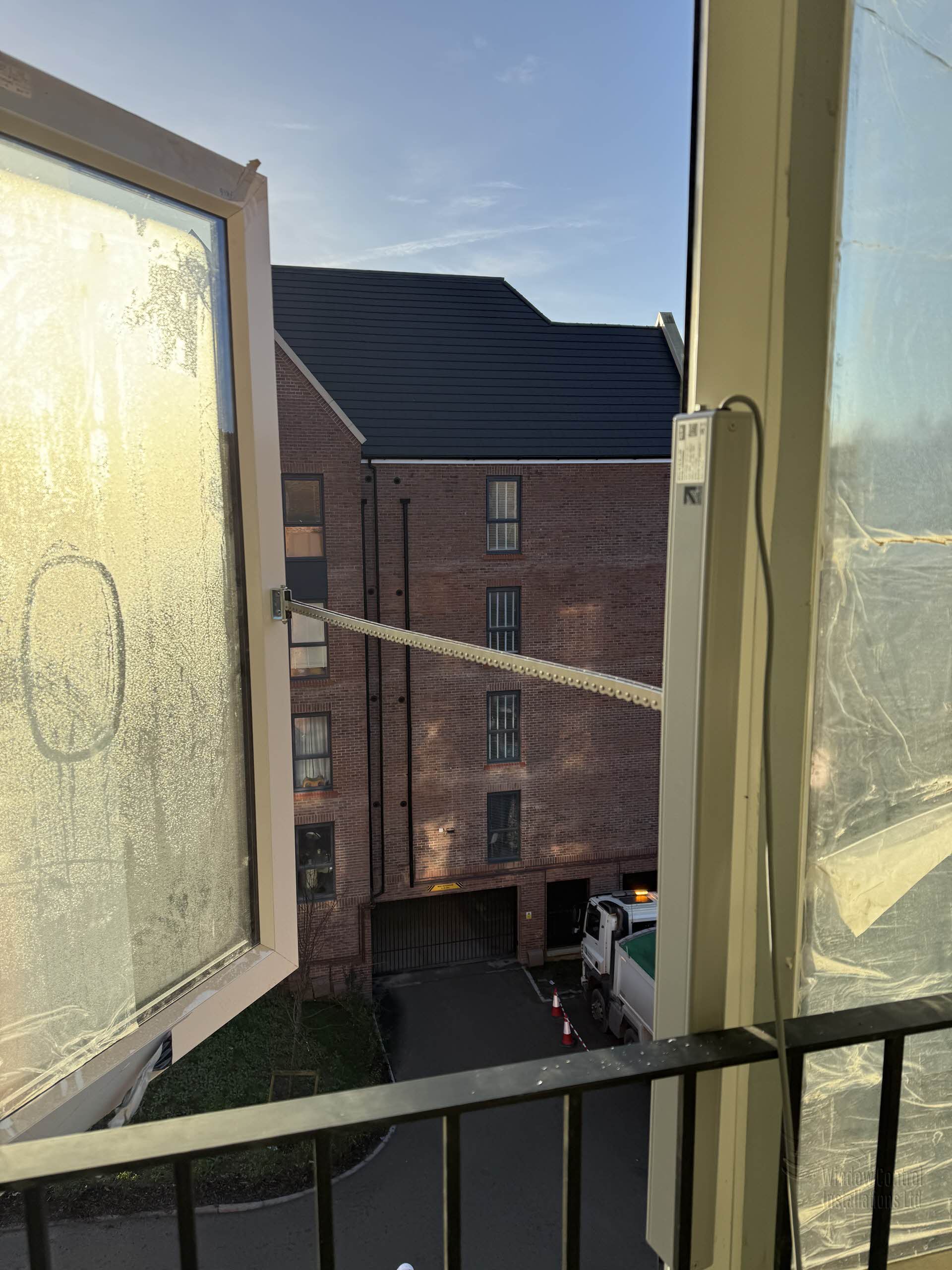 Automatic opening vent (AOV) window fully extended during testing at a new residential apartment complex.