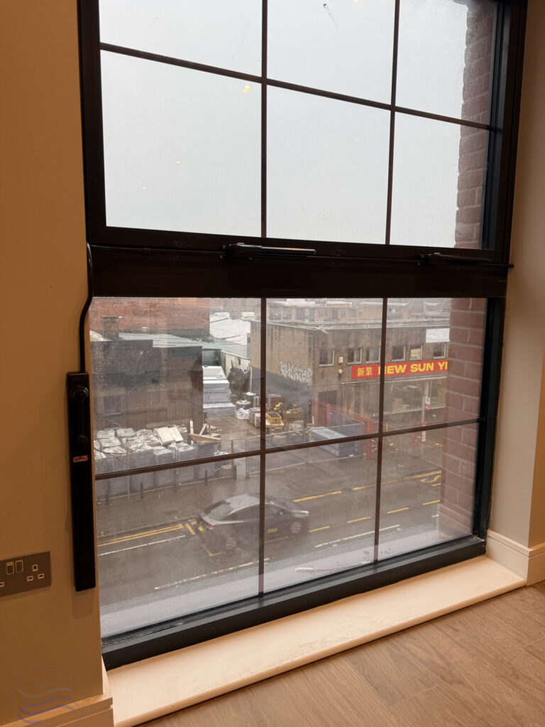 View of the completed Manual Window Control system with matching black hardware for the Lower Essex Street housing project.