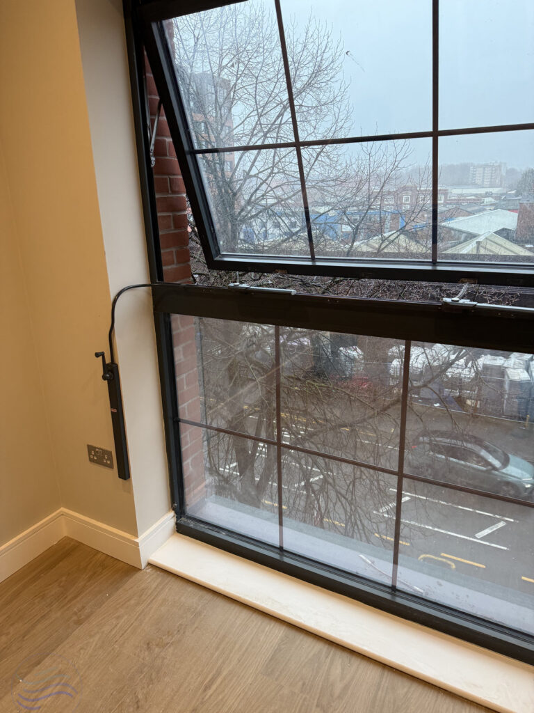 Fully open window showcasing the Teleflex system with 380 Chain Openers and matching black conduit at Lower Essex Street.