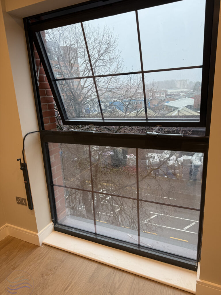 Detail shot of the Teleflex Midi Operator handle in black, installed as part of a manual window control system.